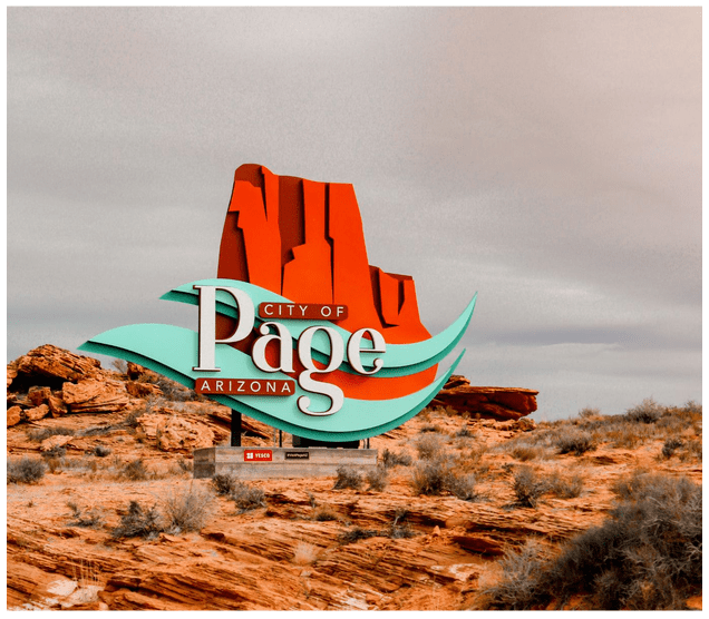 Welcome sign for Page, Arizona with red rock formations and cloudy sky.