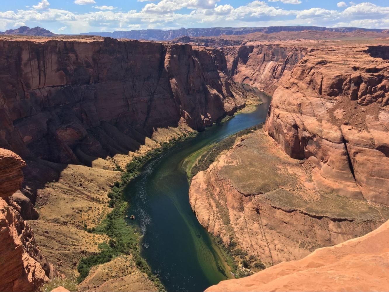 Aerial view of a river winding through a canyon with steep, rocky cliffs.